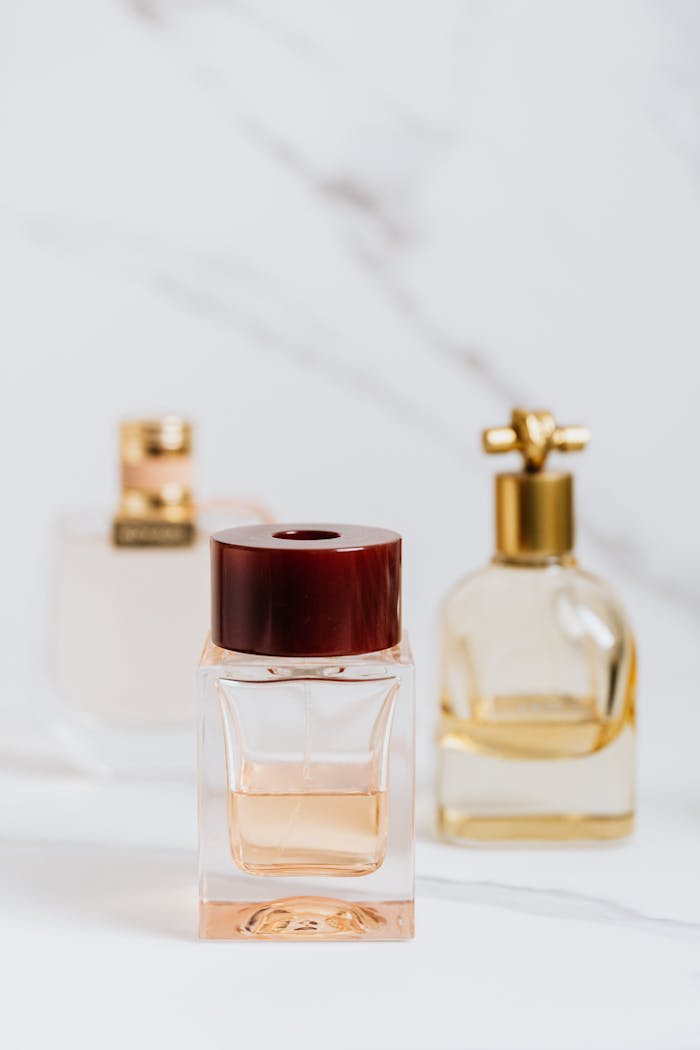 Elegant perfume bottles with gold accents on a stylish marble background.